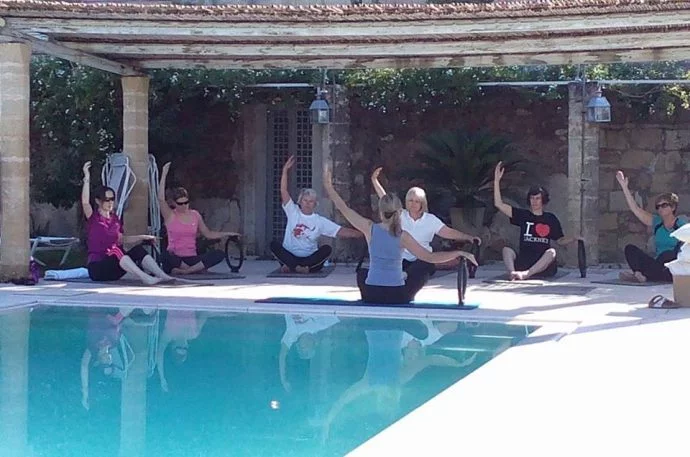 Pilates class by the pool in Italy