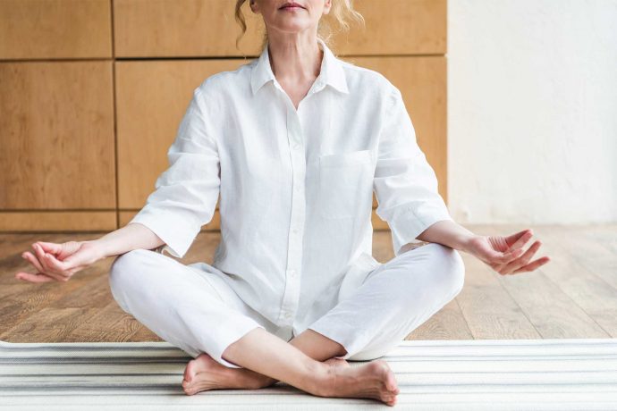 Mature woman meditating in the lotus positio