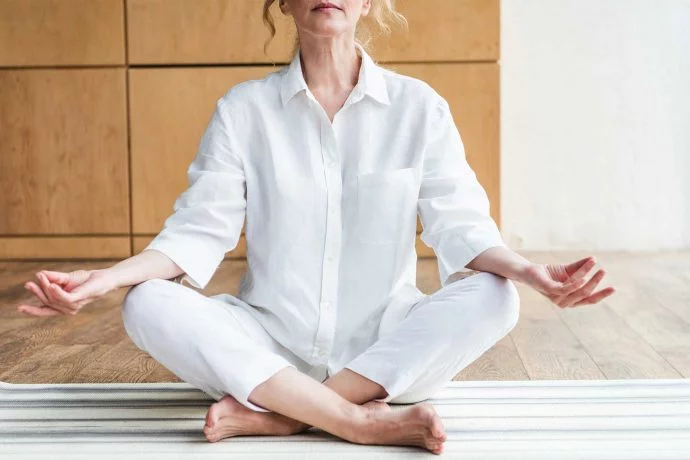 Mature woman meditating in the lotus positio