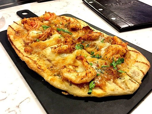 Shrimp and Scampi Flatbread on a stone tray