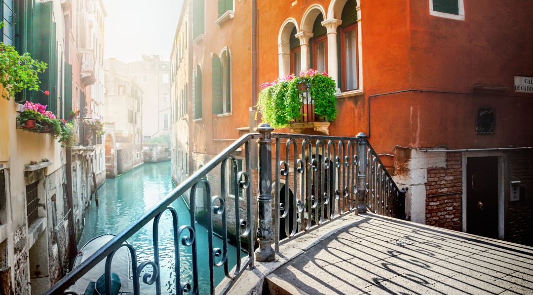 The sun shining down on a canal in Venice