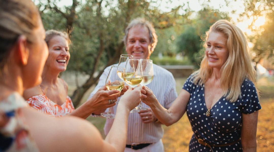 A group of people enjoying a glass of Italian housewine