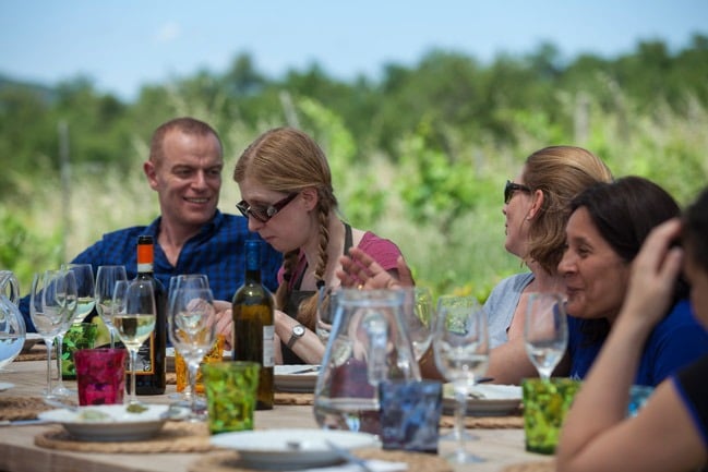 Flavours Holidays guests in Italy eating with wine