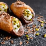 Traditional Sicilian cannoli stuffed with ricotta and pistachios