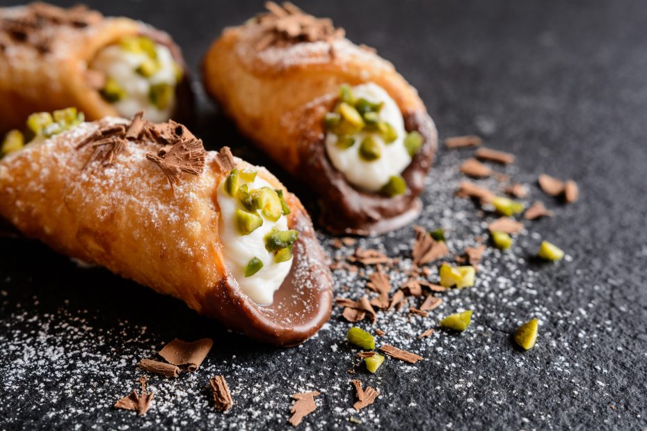 Traditional Sicilian cannoli stuffed with ricotta and pistachios