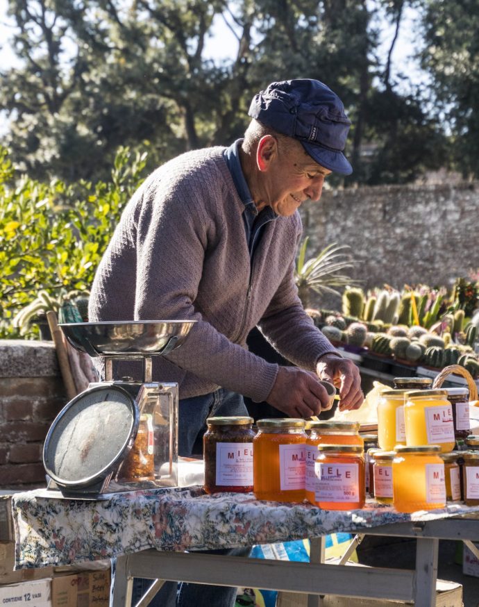 Photographing the beekeeper seling his honey at the local market.