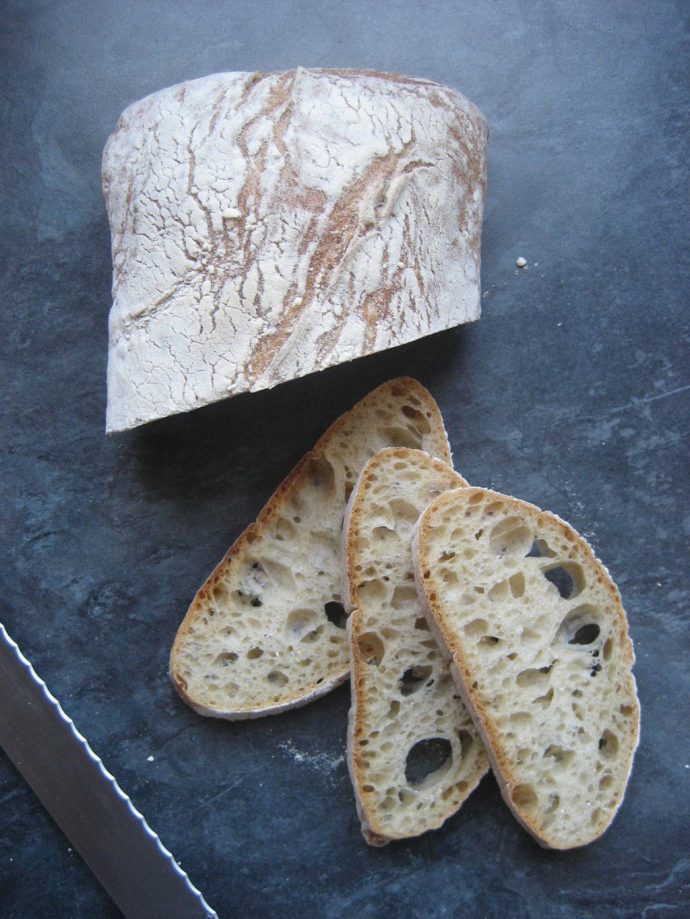 Ciabatta bread cut on a table top