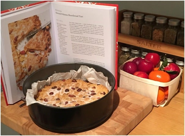 Almond Polenta Shortbread Tart on kitchen bench with fruit and cookbook