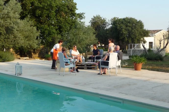 Guests Relaxing Chatting by the Pool