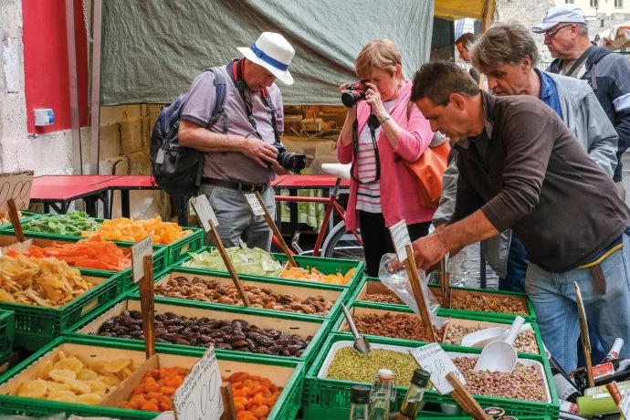 A group of guests taking a picture of the local markets