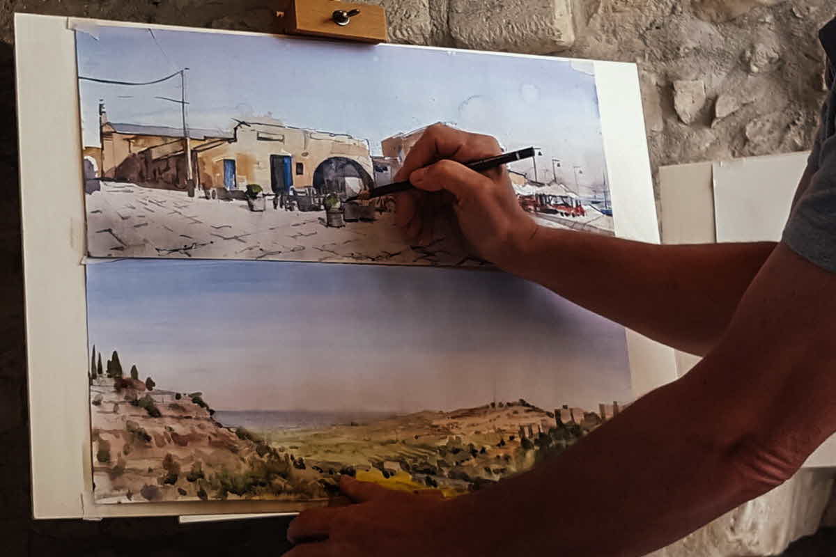 Artist carefully putting the finishing touches to their watercolours.