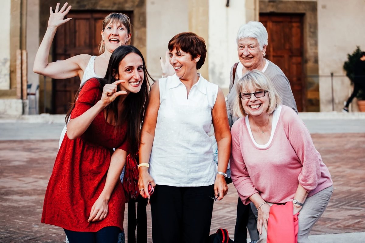  Group of women, of varying ages, laughing and smiling together