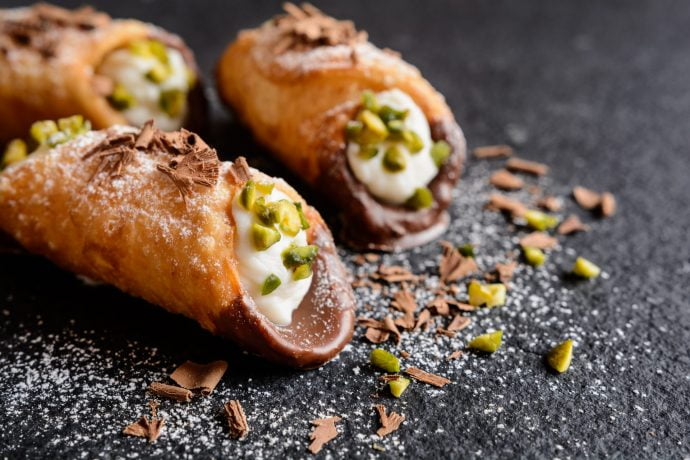 Cannoli di ricotta dipped in chocolate and pistachios