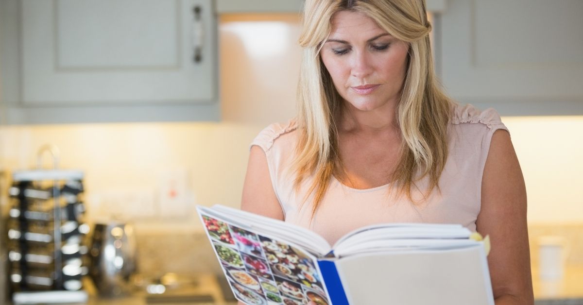 Lady looking at cookbook