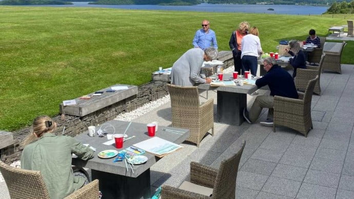 Tutor Mark painting with guests at Loch Lomond 