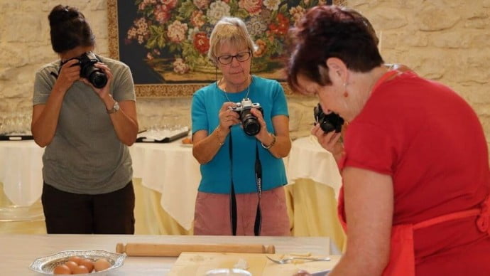Ladies photographing food on a solo travel activity holiday