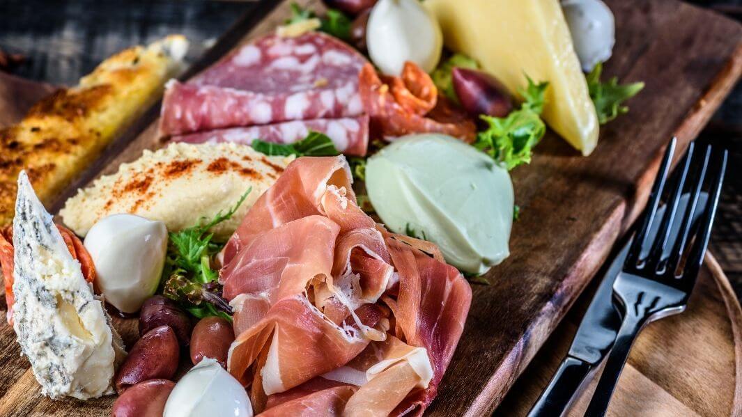 Various meats and cheeses on an antipasto board