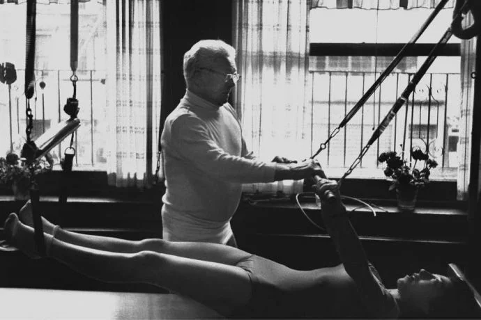 Joseph Pilates teaching his student