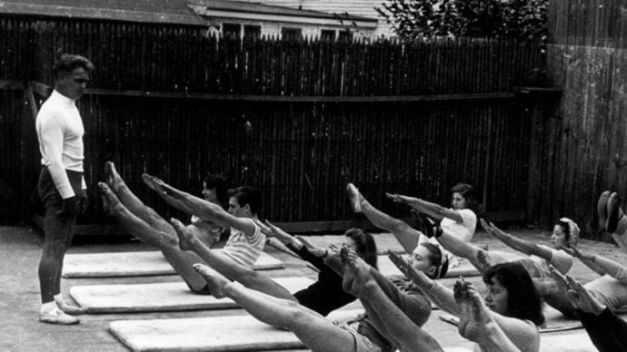 Joseph Pilates teaching pilates students outside