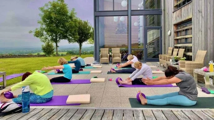 Flavours Holidays Pilates class outside in Loch Lomond Flavours Holidays Pilates class outside in Loch Lomond
