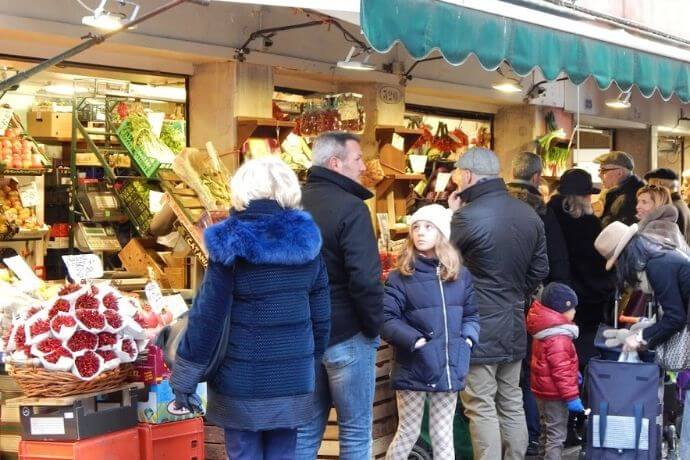 A group of people at a Venetian market