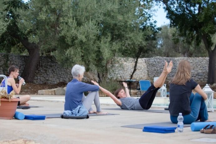 A Pilates class increasing their flexibility