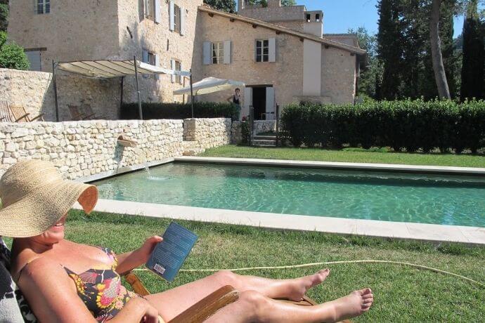 A woman chilling at the pool on her solo holiday