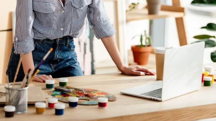 A woman joining a painting class online