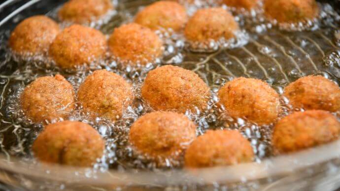 Ascolana olives frying in oil to be served with Pecorino