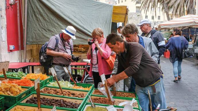 A group of guests taking a picture of the local markets