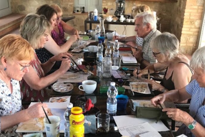 A group of painters painting together in Tuscany