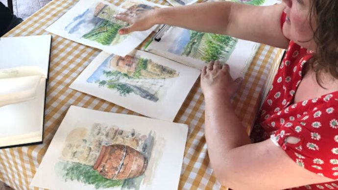 One of our painting tutors looking over paintings