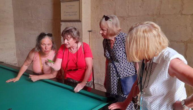 A group of ladies reading Italian off of a piece of paper