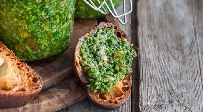 Pesto spread onto bread which is a cooking tip to be ignored in Italy
