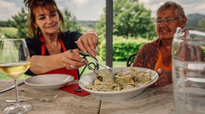 Travellers enjoying the food they've made on a cooking holiday