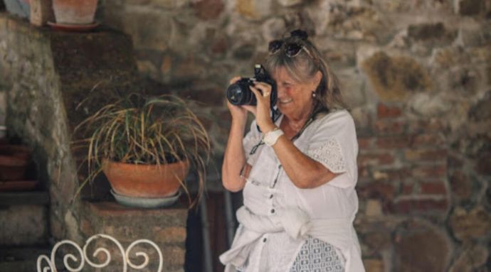 A woman capturing photographs in the shining sun