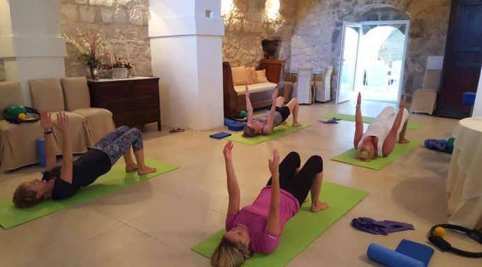 A group of ladies exercising in a traditional villa in Italy