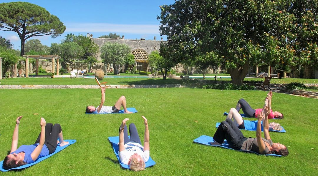 A group of ladies doing yoga under the sun