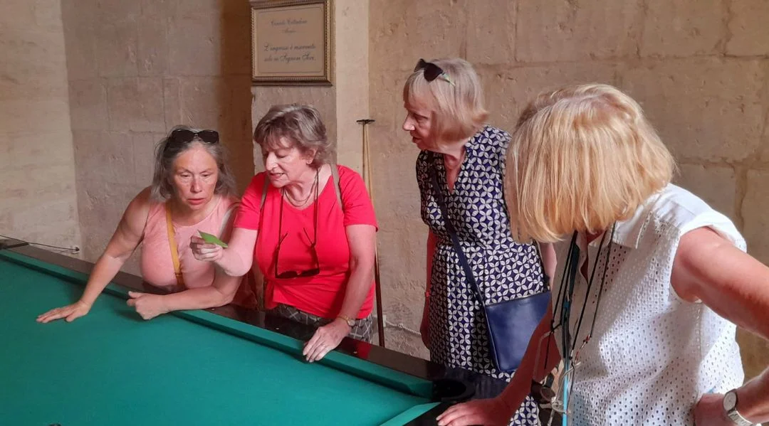 A group of ladies playing a game in Italian to improve their skills