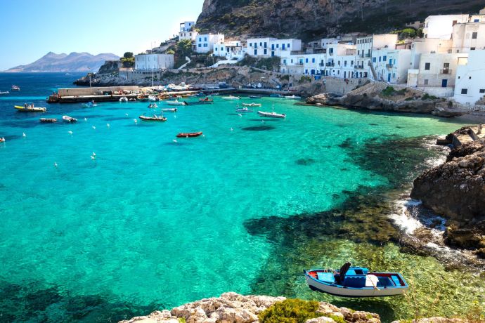 Trapani bay, beautiful blue water with boats and onlooking houses
