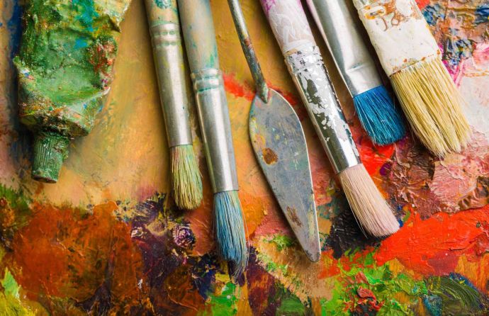 Paint brushes on a paint palette – are you looking for art competitions?