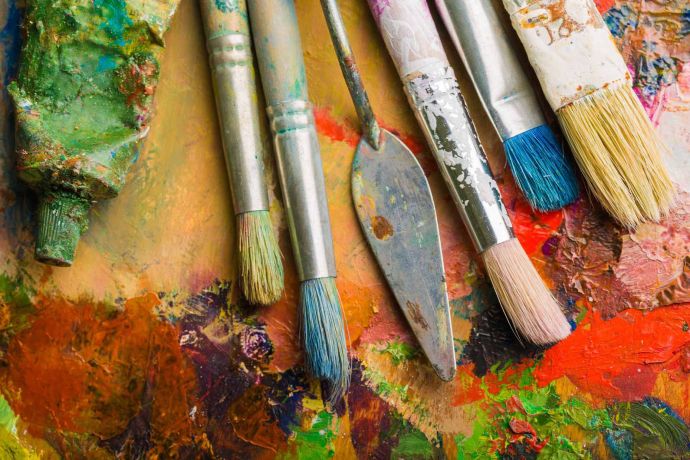 Paint brushes on a paint palette – are you looking for art competitions?