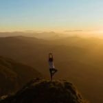 Yoga pose in the mountains - our favourite wellness podcasts for this year