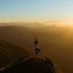 Yoga pose in the mountains - our favourite wellness podcasts for this year