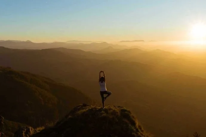 Yoga pose in the mountains - our favourite wellness podcasts for this year