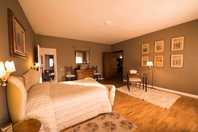 A bedroom in Villa Domenica bathed in warm light