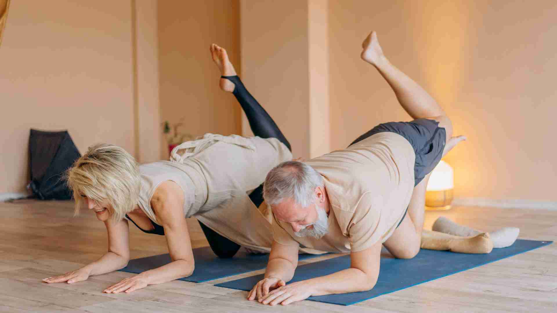 In a yoga pose during a yoga class.