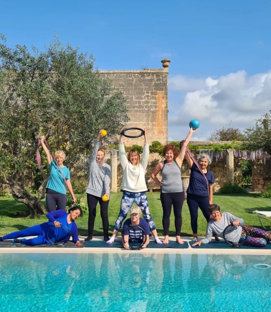 Highly experienced Body Control Pilates instructor with her Pilates class.