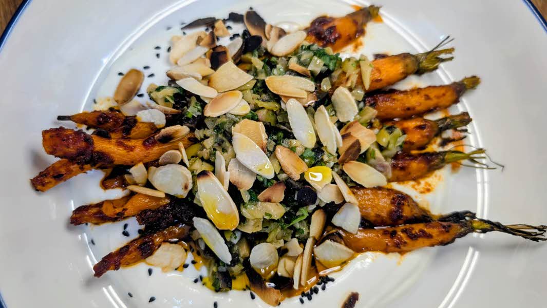 Harissa roasted carrots with olive, preserved lemon & coriander salsa.