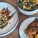 Sticky orange and turmeric chicken skewers, harissa roasted carrots and bitter leaf salad.